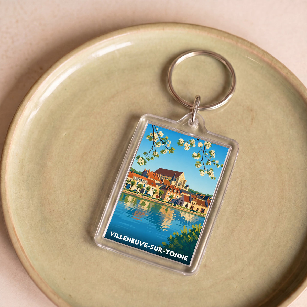 Porte-clés souvenir de la ville de Villeneuve-sur-Yonne avec une illustration stylisée.