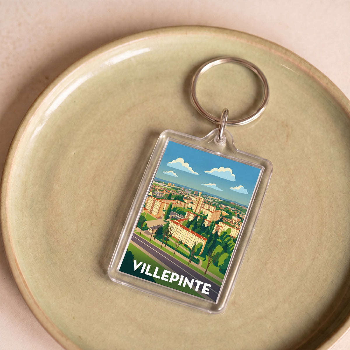 Porte-clés souvenir de la ville de Villepinte avec une illustration stylisée.