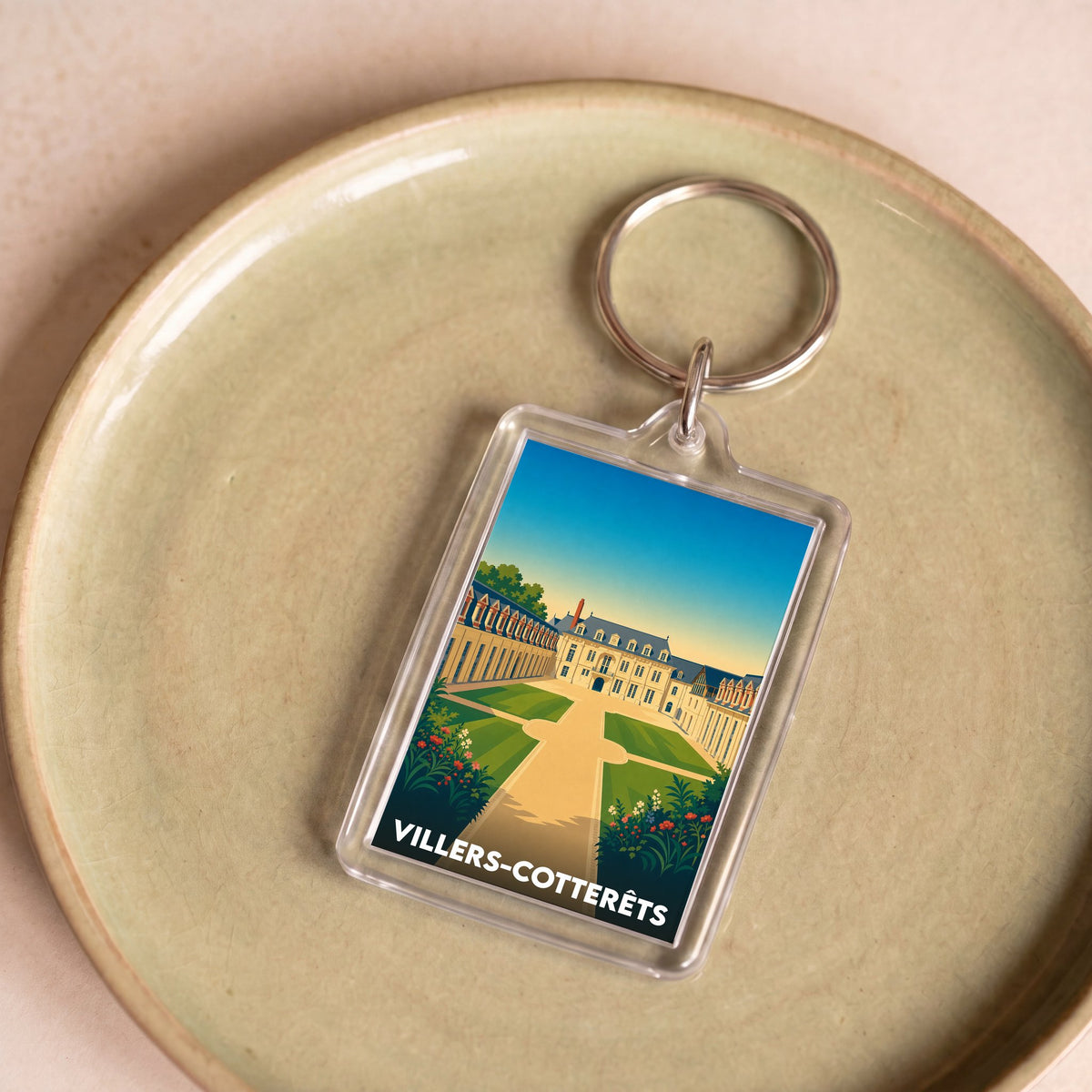 Porte-clés souvenir de la ville de Villers-Cotterêts avec une illustration stylisée de son château.