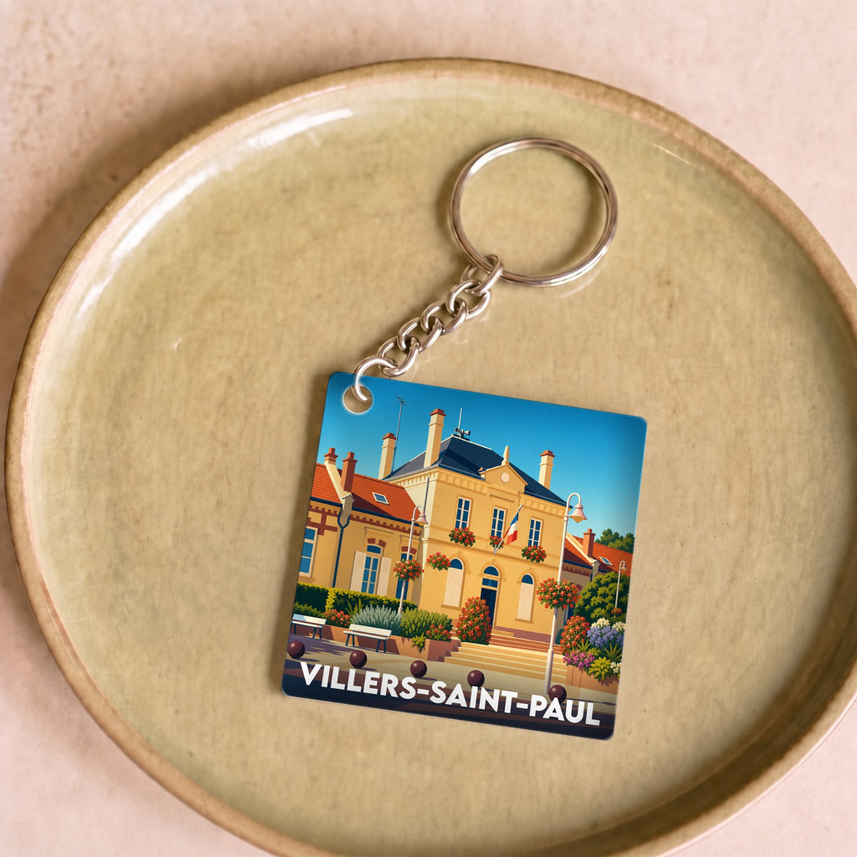 Porte-clés souvenir de la ville de Villers-Saint-Paul avec une illustration stylisée de l'hôtel de ville.