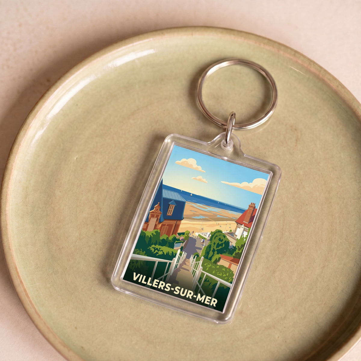 Porte-clés souvenir de la ville de Villers-sur-Mer avec une illustration stylisée.