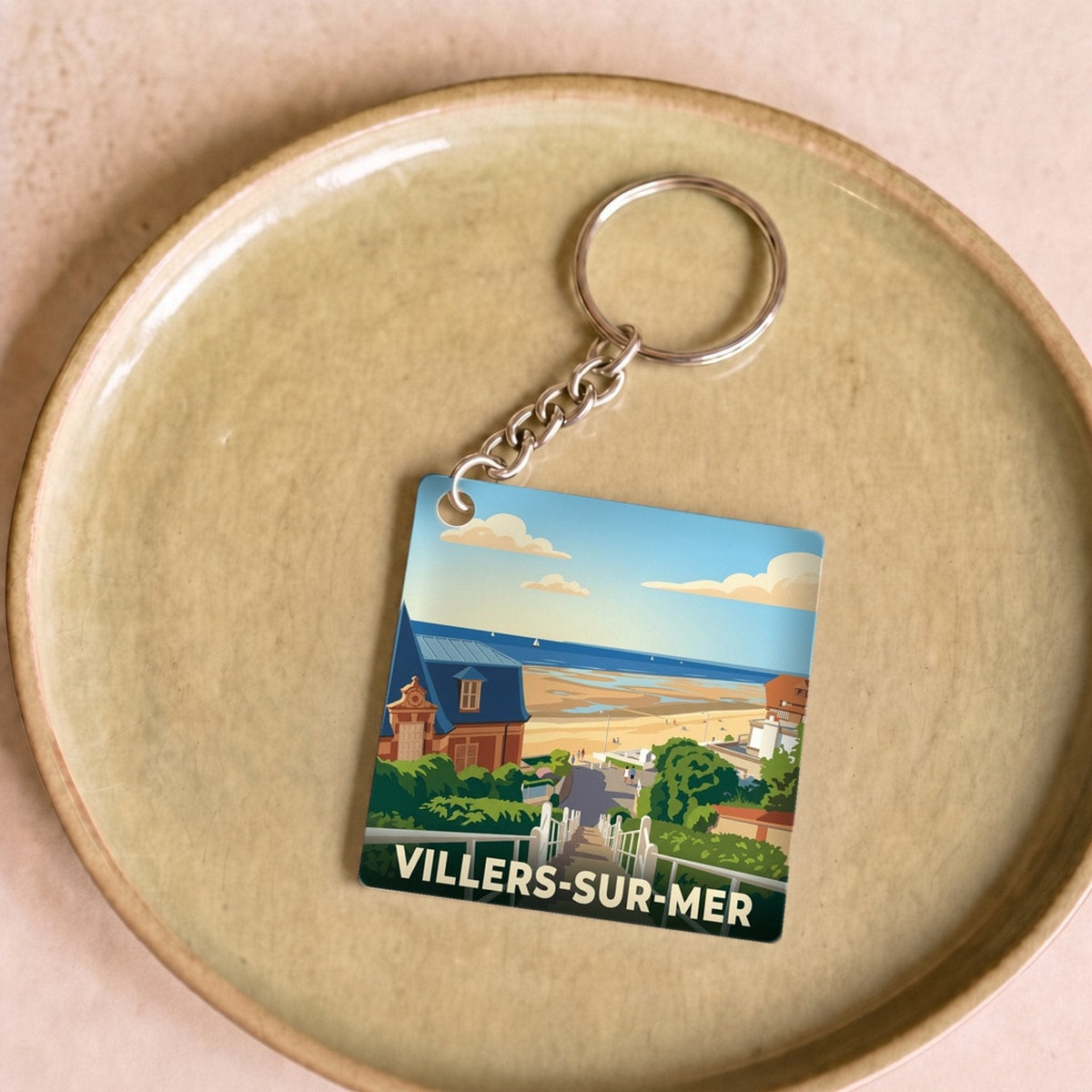 Porte-clés souvenir de la ville de Villers-sur-Mer avec une illustration stylisée.