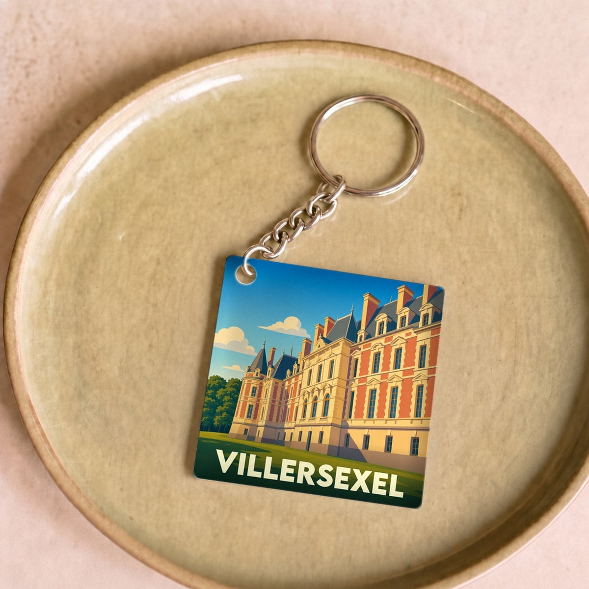 Porte-clés souvenir de la ville de Villersexel avec une illustration stylisée de son château.