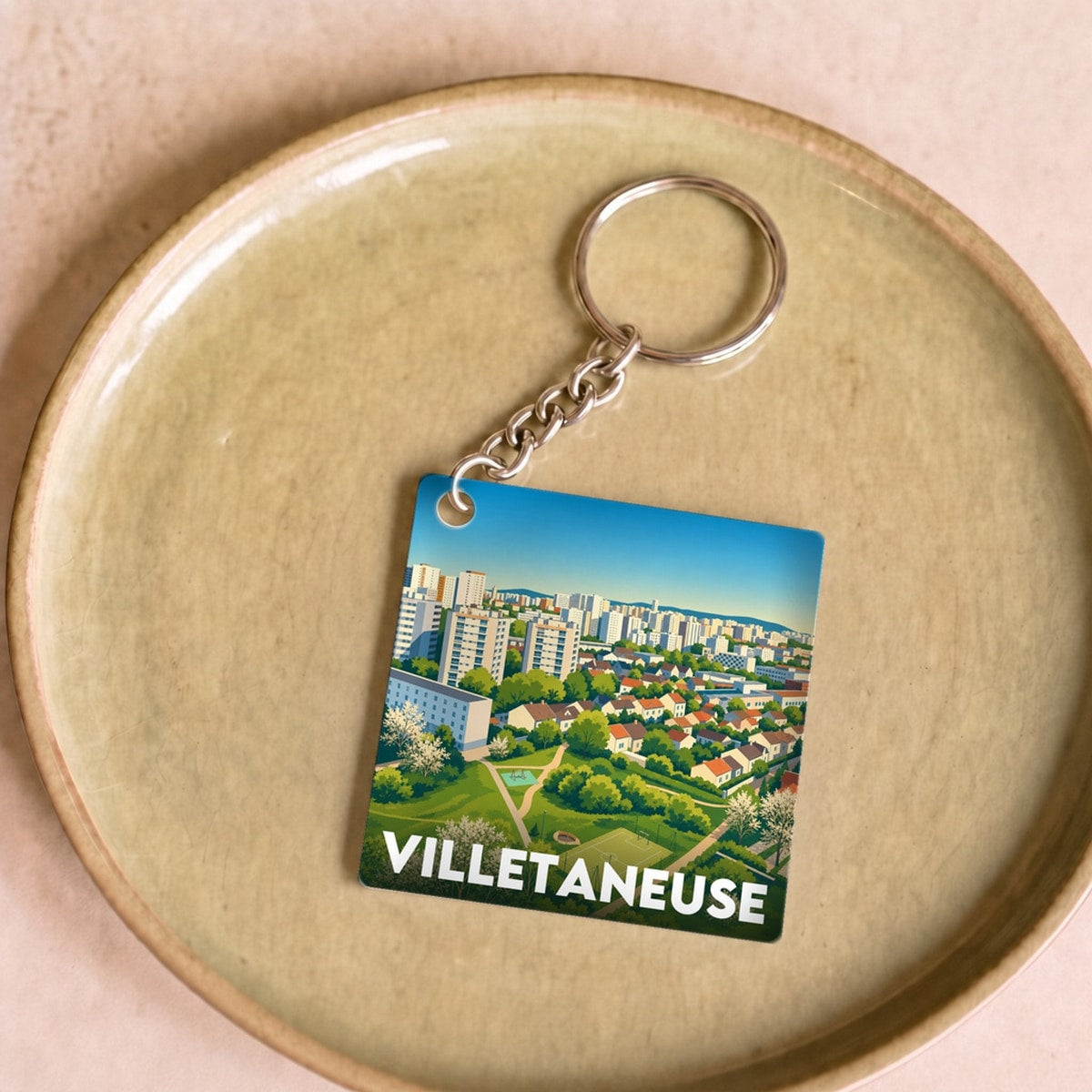 Porte-clés souvenir de la ville de Villetaneuse avec une illustration stylisée.