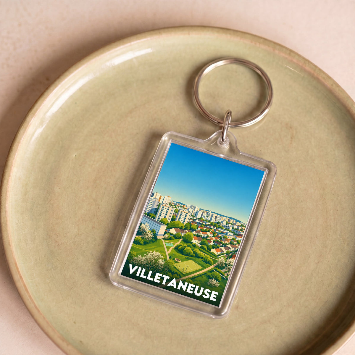 Porte-clés souvenir de la ville de Villetaneuse avec une illustration stylisée.