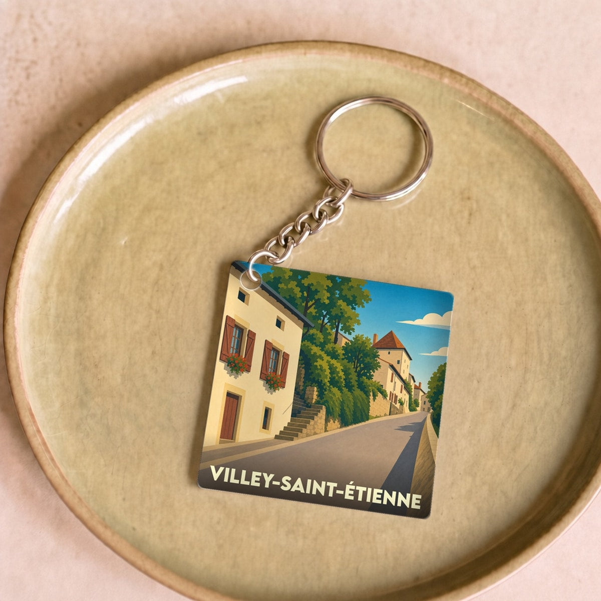 Porte-clés souvenir de la ville de Villey-Saint-Étienne avec une illustration stylisée.
