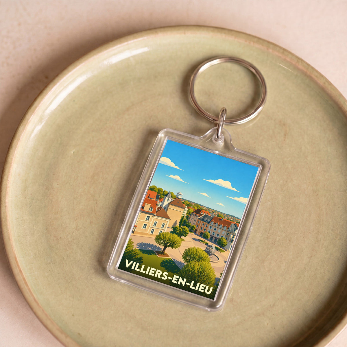 Porte-clés souvenir de la ville de Villiers-en-Lieu avec une illustration stylisée.