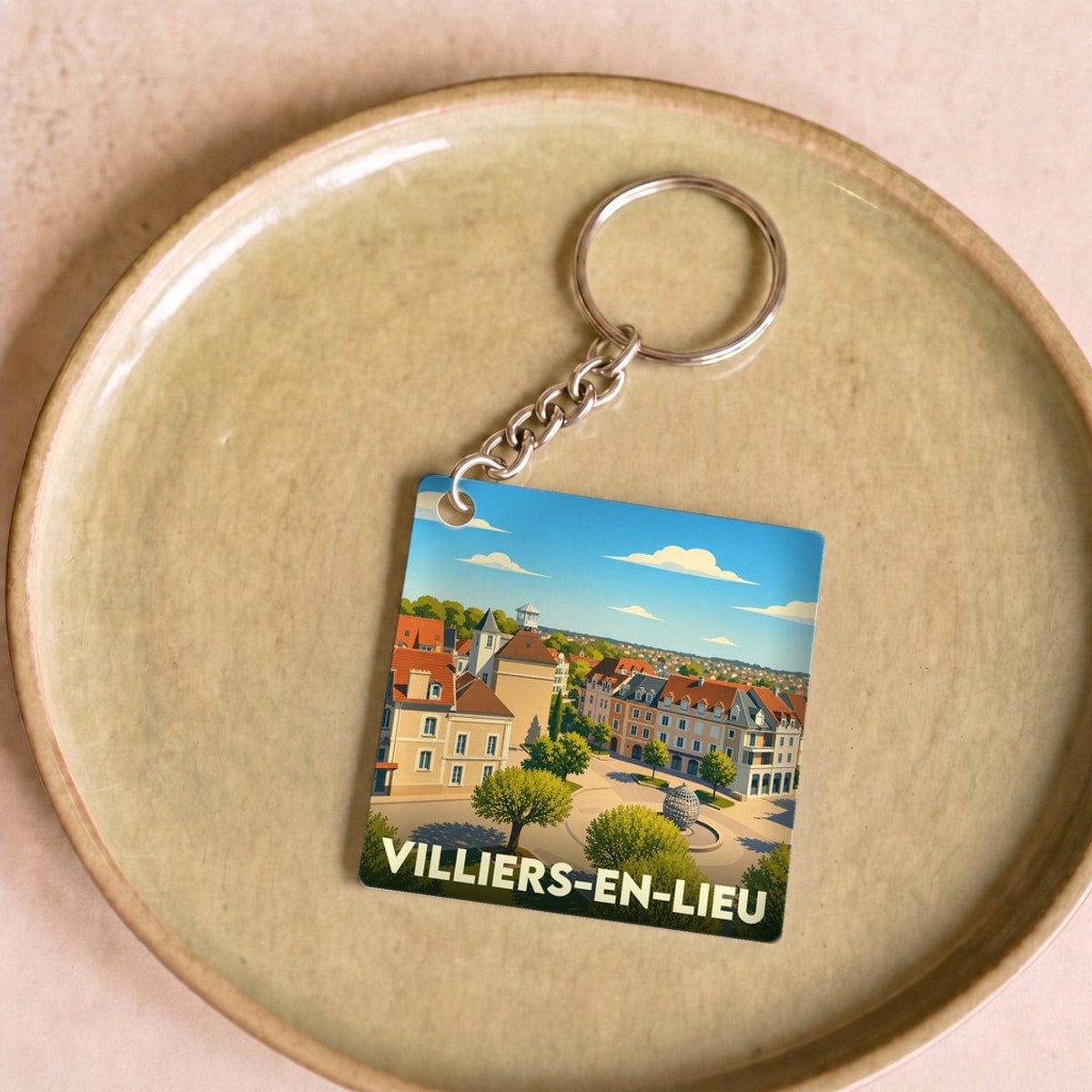 Porte-clés souvenir de la ville de Villiers-en-Lieu avec une illustration stylisée.