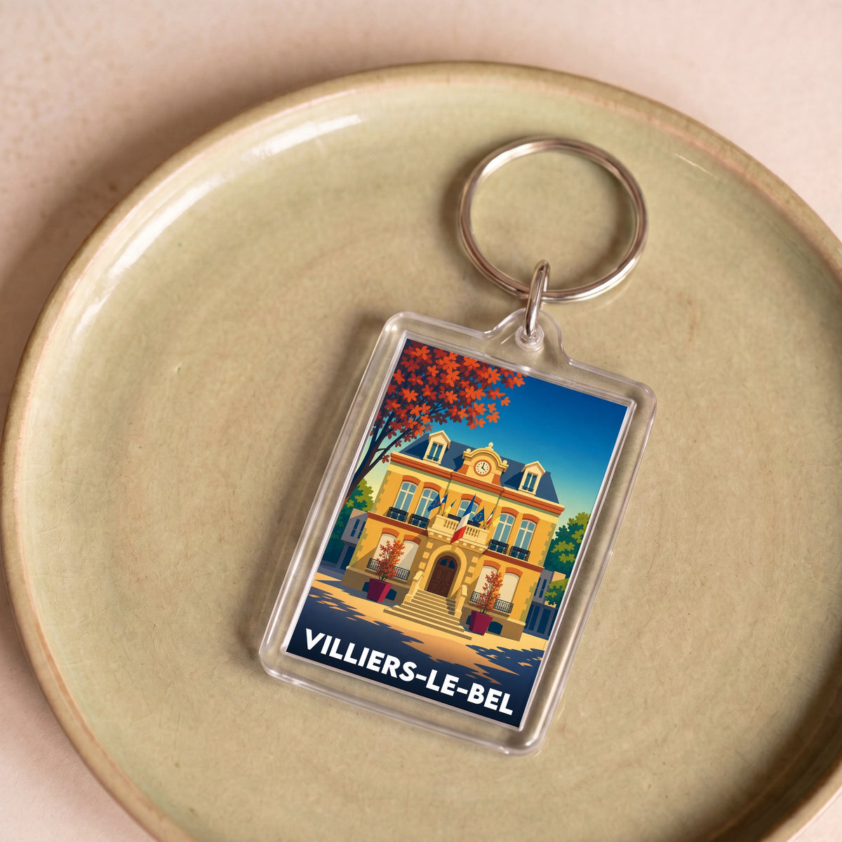 Porte-clés souvenir de la ville de Villiers-le-Bel avec une illustration stylisée et colorée.