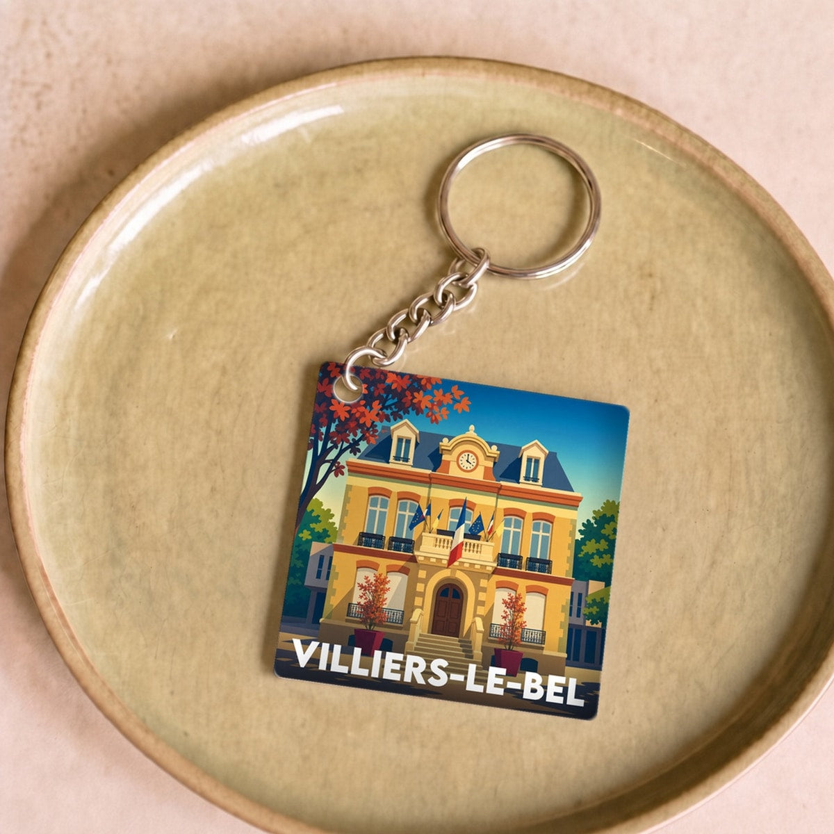 Porte-clés souvenir de la ville de Villiers-le-Bel avec une illustration stylisée et colorée.