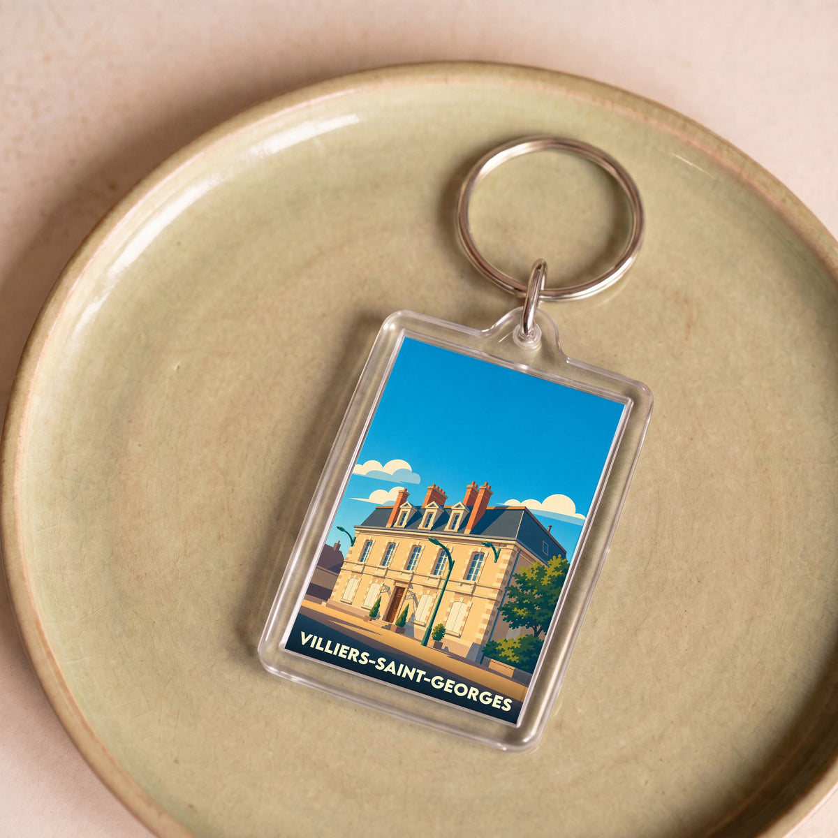 Porte-clés souvenir de la ville de Villiers-Saint-Georges avec une illustration stylisée.