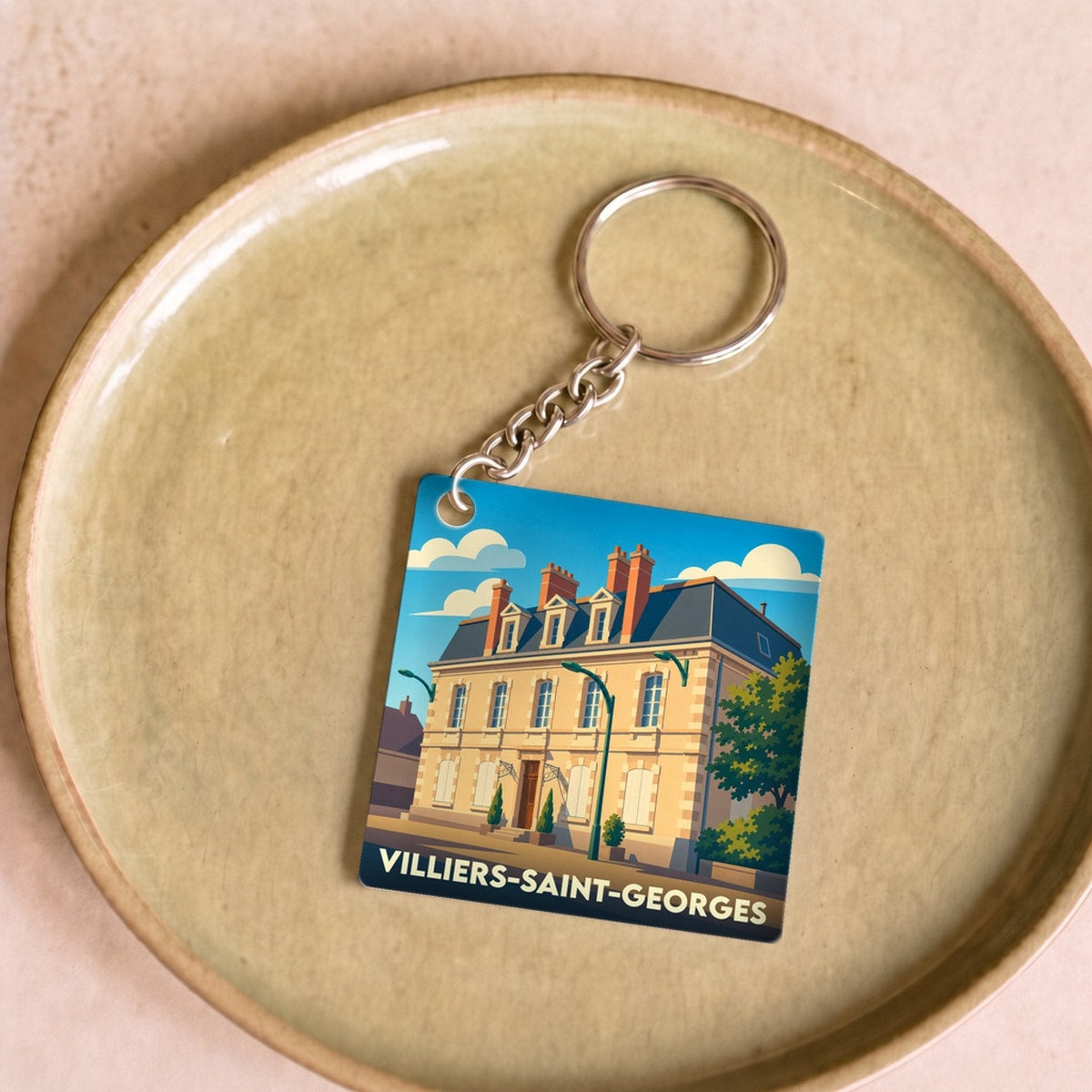 Porte-clés souvenir de la ville de Villiers-Saint-Georges avec une illustration stylisée.