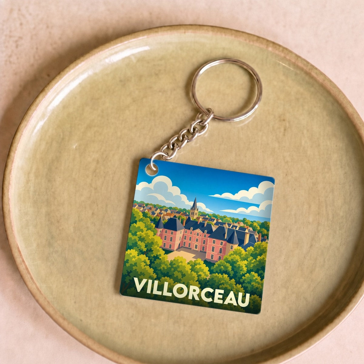 Porte-clés souvenir de la ville de Villorceau avec une illustration stylisée.