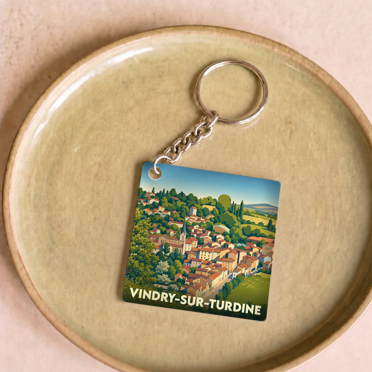 Porte-clés souvenir de la ville de Vindry-sur-Turdine avec une illustration stylisée.