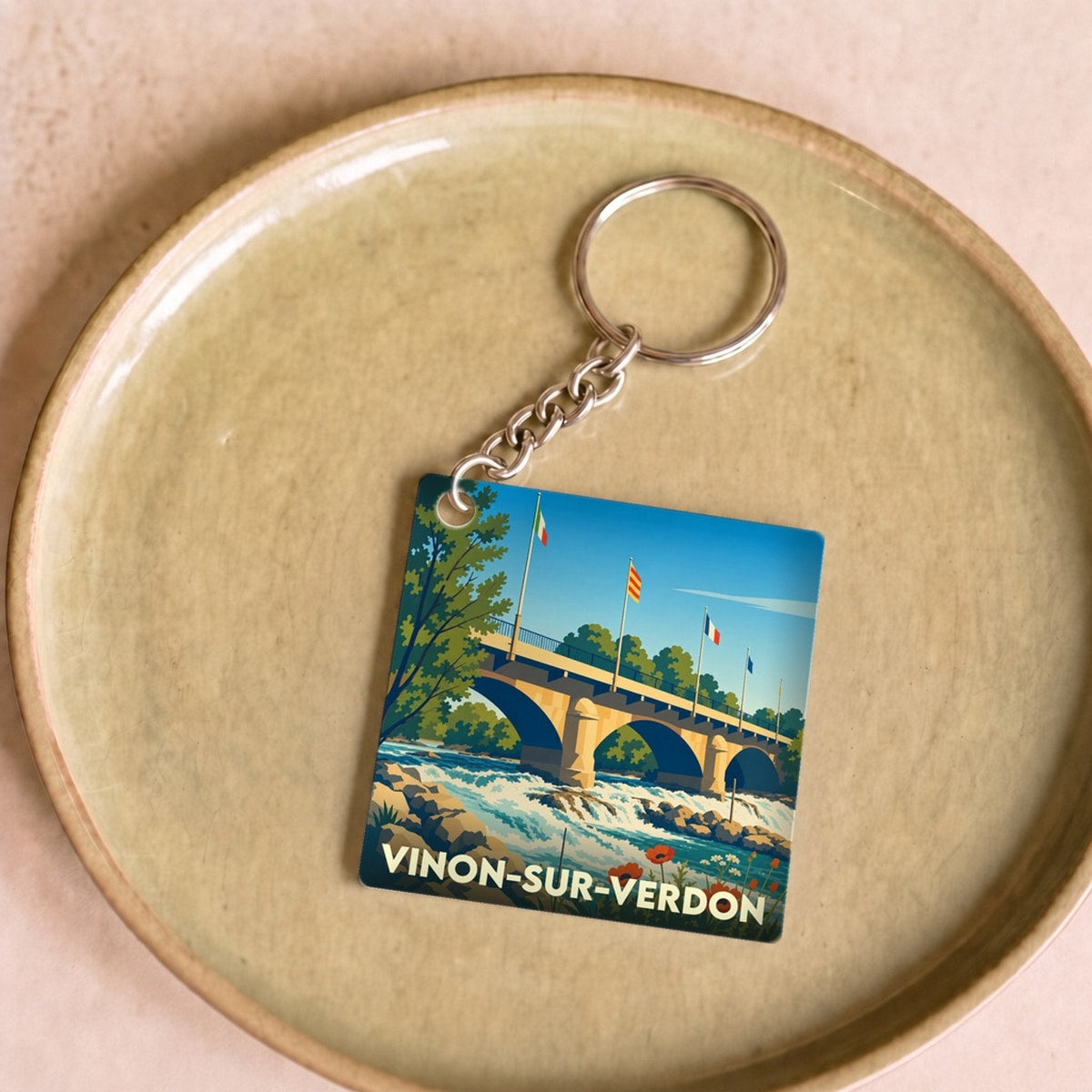 Porte-clés souvenir de la ville de Vinon-sur-Verdon avec une illustration stylisée de son pont et de la rivière.