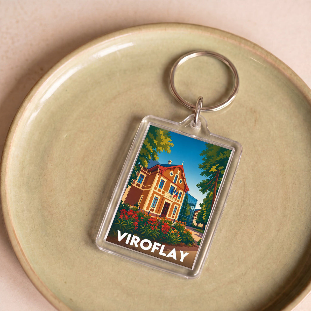 Porte-clés souvenir de la ville de Viroflay avec une illustration stylisée d'une demeure historique.
