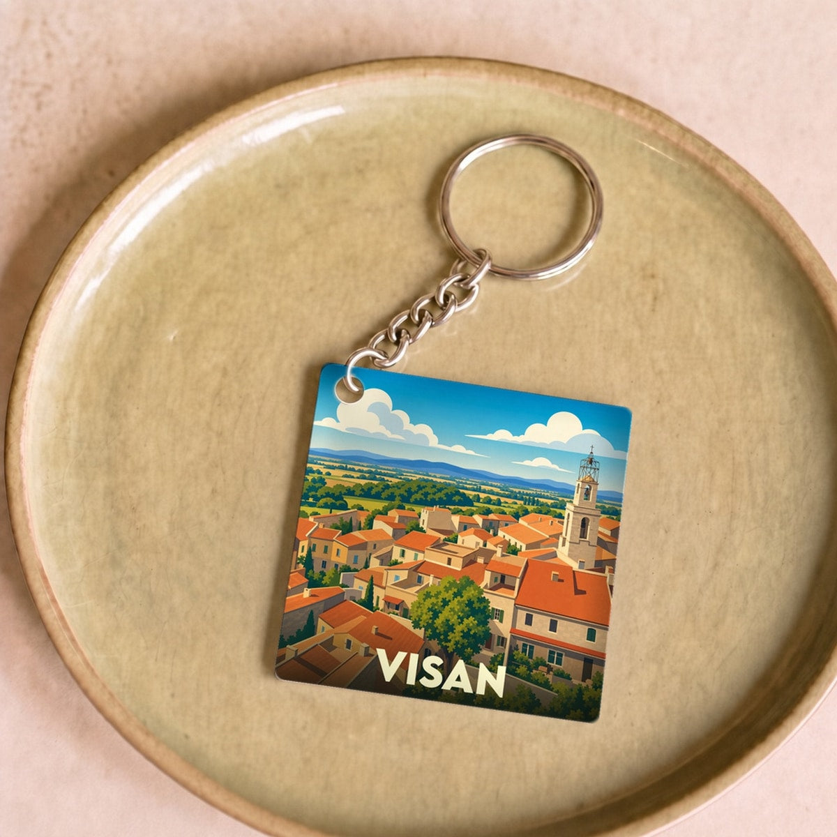 Porte-clés souvenir de la ville de Visan avec une illustration stylisée.