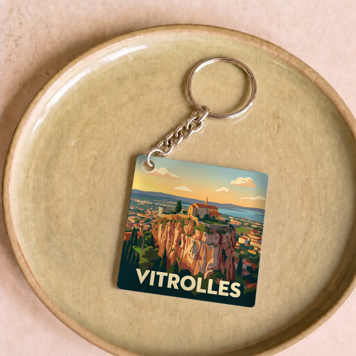 Porte-clés souvenir de la ville de Vitrolles avec une illustration stylisée.