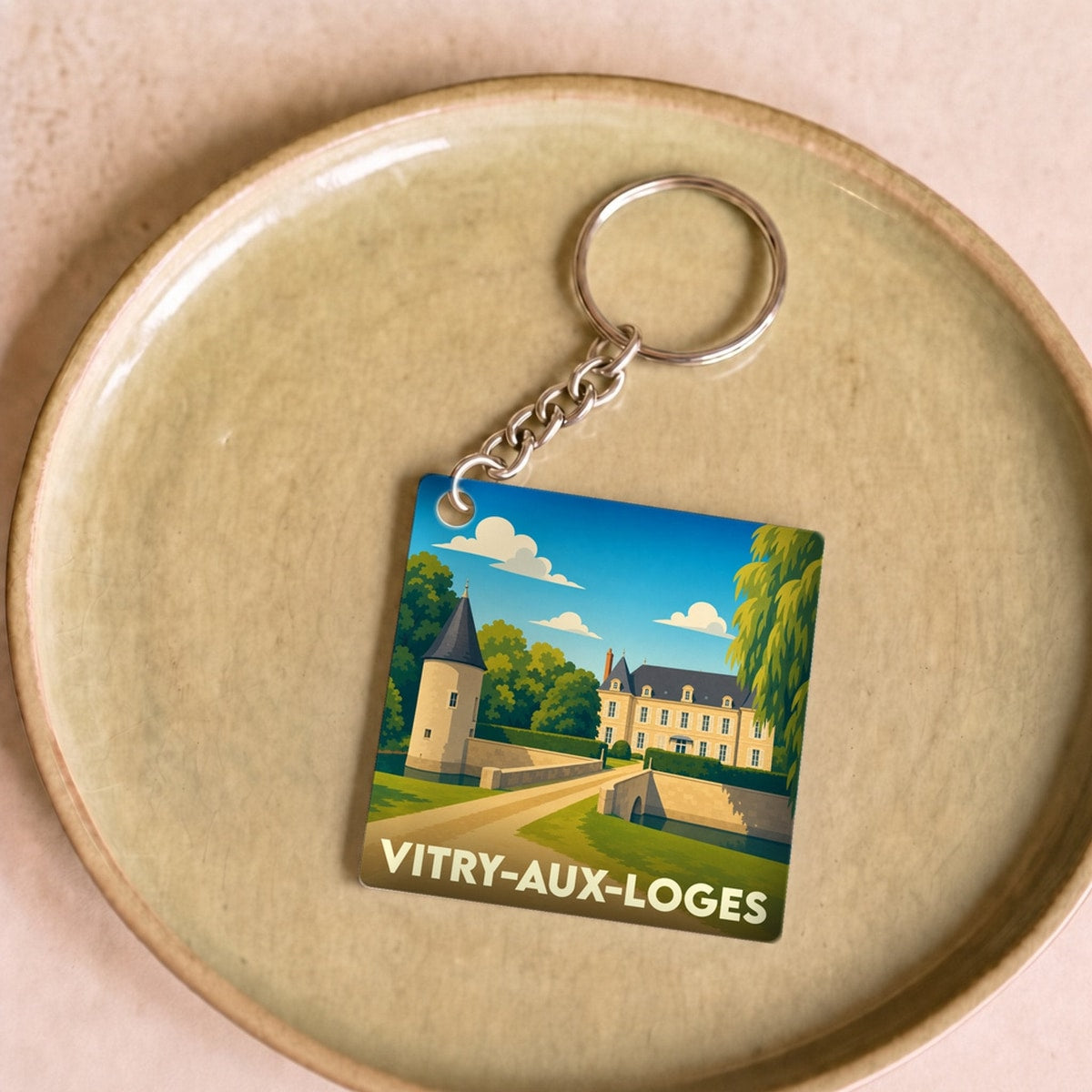 Porte-clés souvenir de la ville de Vitry-aux-Loges avec une illustration stylisée de son château.