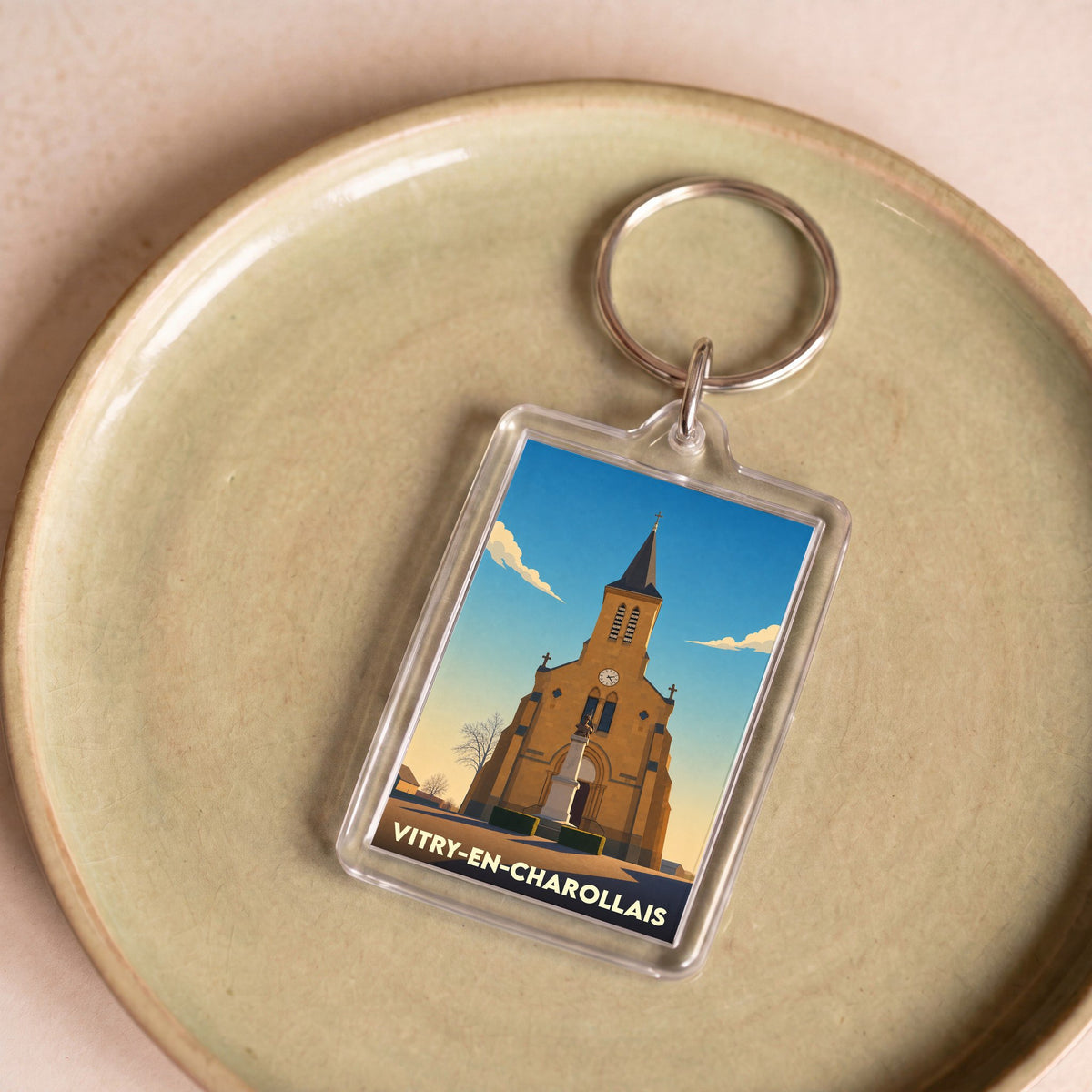 Porte-clés souvenir de la ville de Vitry-en-Charollais avec une illustration stylisée de son église.