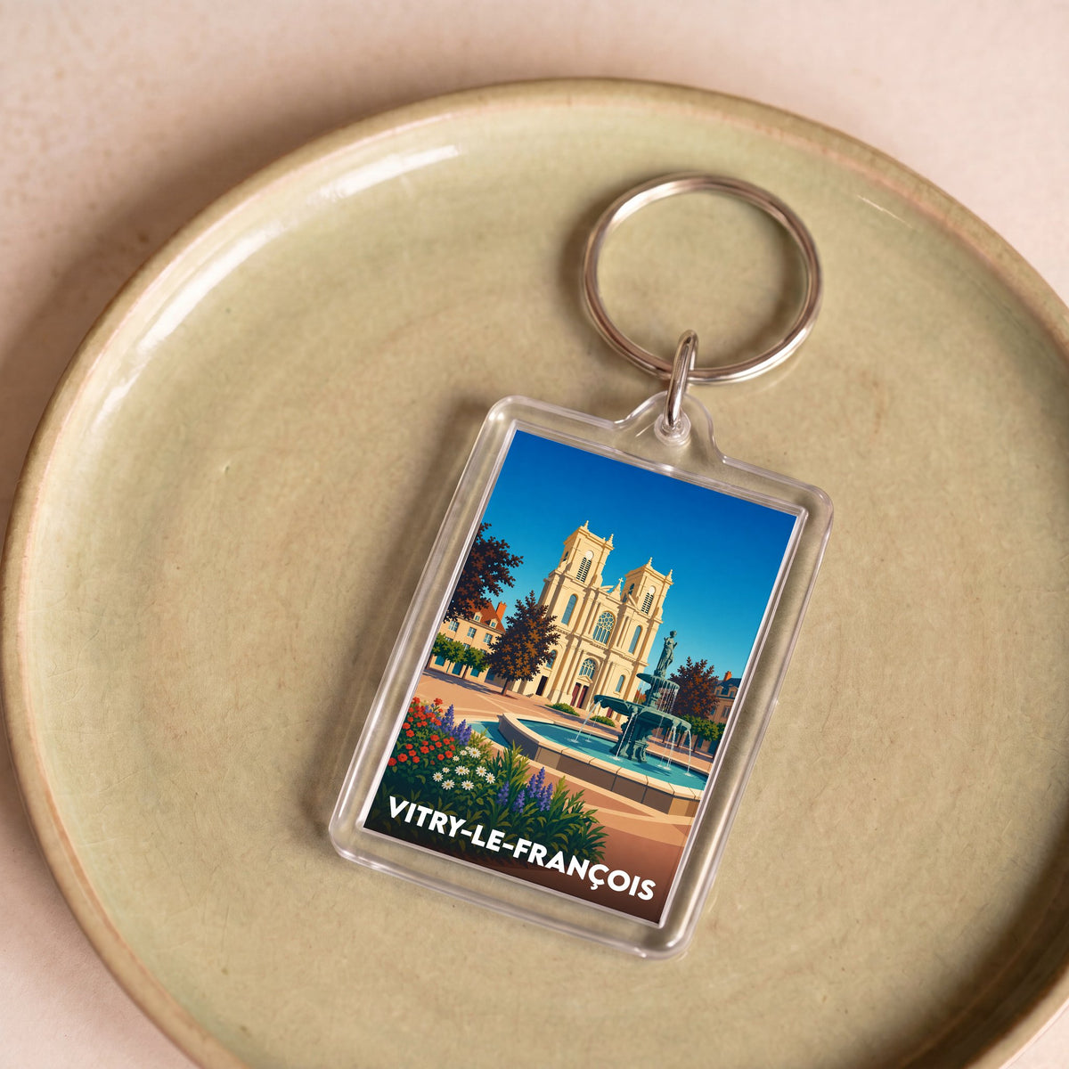 Porte-clés souvenir de la ville de Vitry-le-François avec une illustration stylisée.