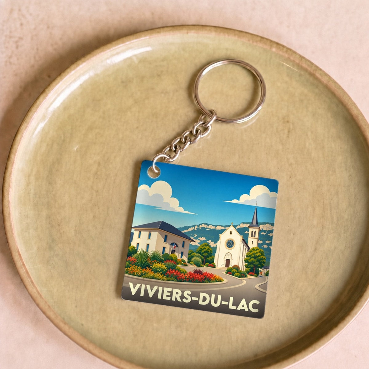 Porte-clés souvenir de la ville de Viviers-du-Lac avec une illustration stylisée.