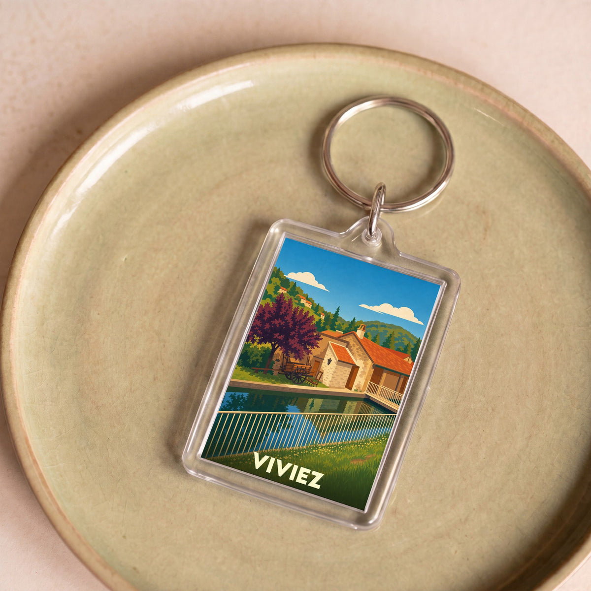 Porte-clés souvenir de la ville de Viviez avec une illustration stylisée.