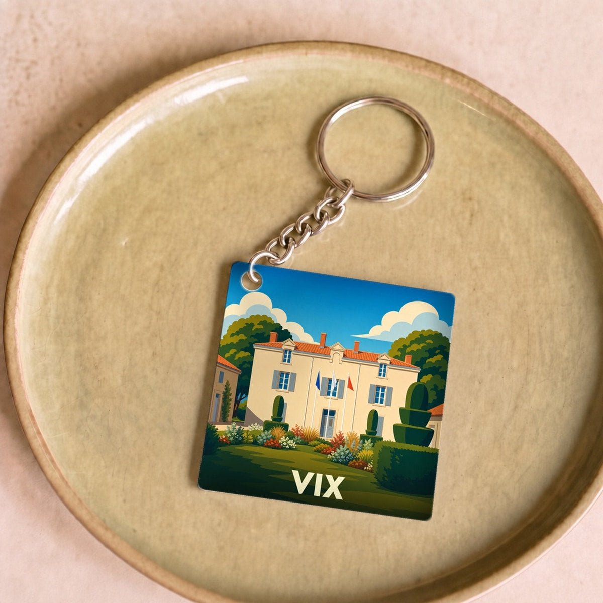 Porte-clés souvenir de la ville de Vix avec une illustration stylisée de sa mairie.
