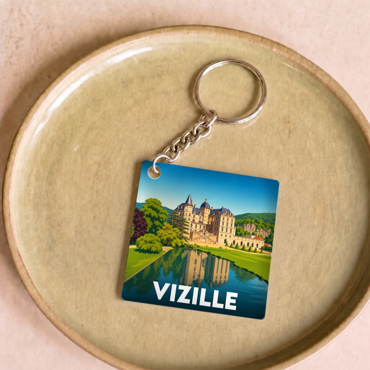 Porte-clés souvenir de la ville de Vizille avec une illustration stylisée de son château.