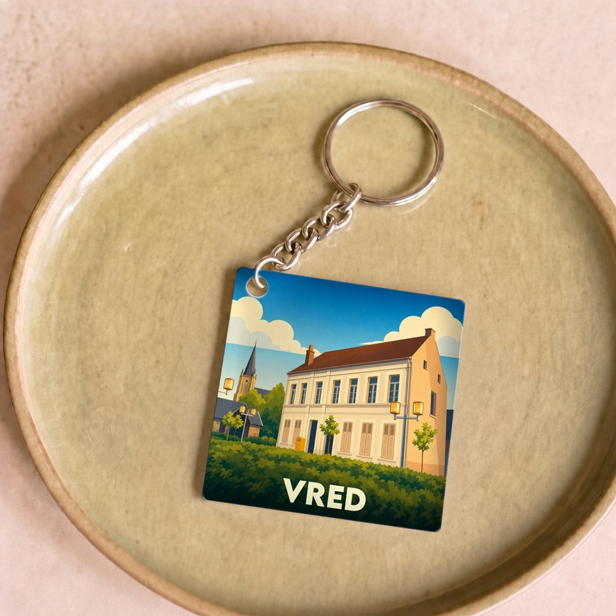 Porte-clés souvenir de la ville de Vred avec une illustration stylisée.