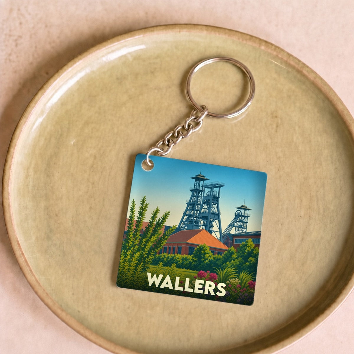 Porte-clés souvenir de la ville de Wallers avec une illustration stylisée de ses anciens chevalements miniers.