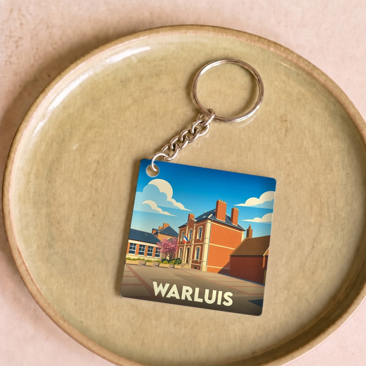 Porte-clés souvenir de la ville de Warluis avec une illustration stylisée.