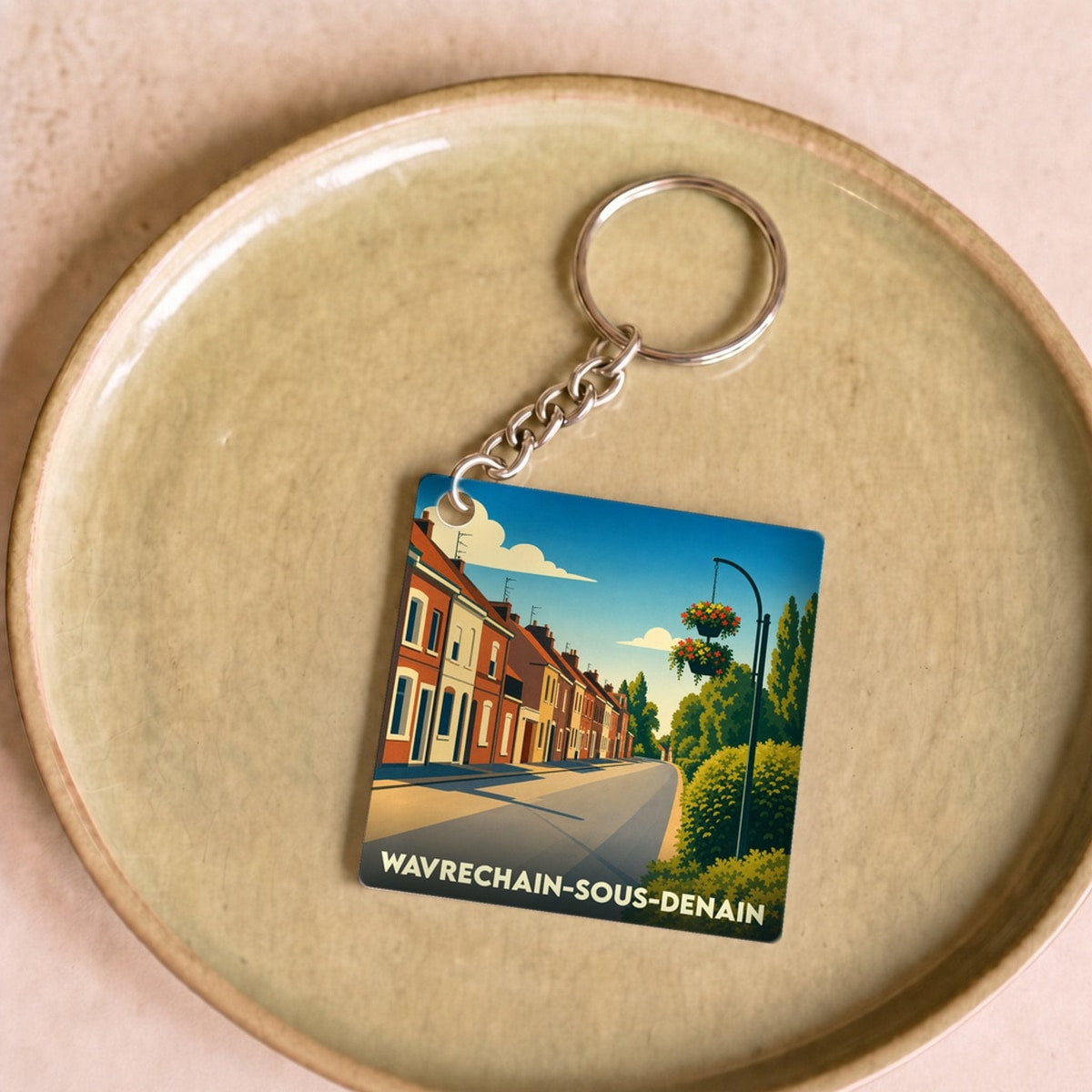 Porte-clés souvenir de la ville de Wavrechain-sous-Denain avec une illustration stylisée.