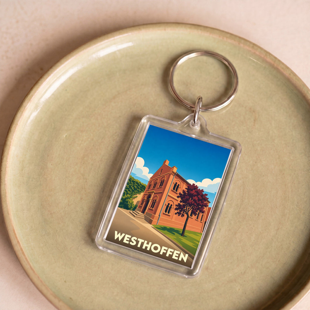 Porte-clés souvenir de la ville de Westhoffen avec une illustration stylisée.