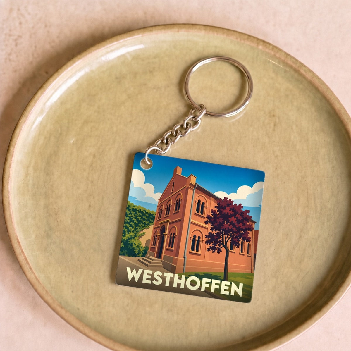 Porte-clés souvenir de la ville de Westhoffen avec une illustration stylisée.