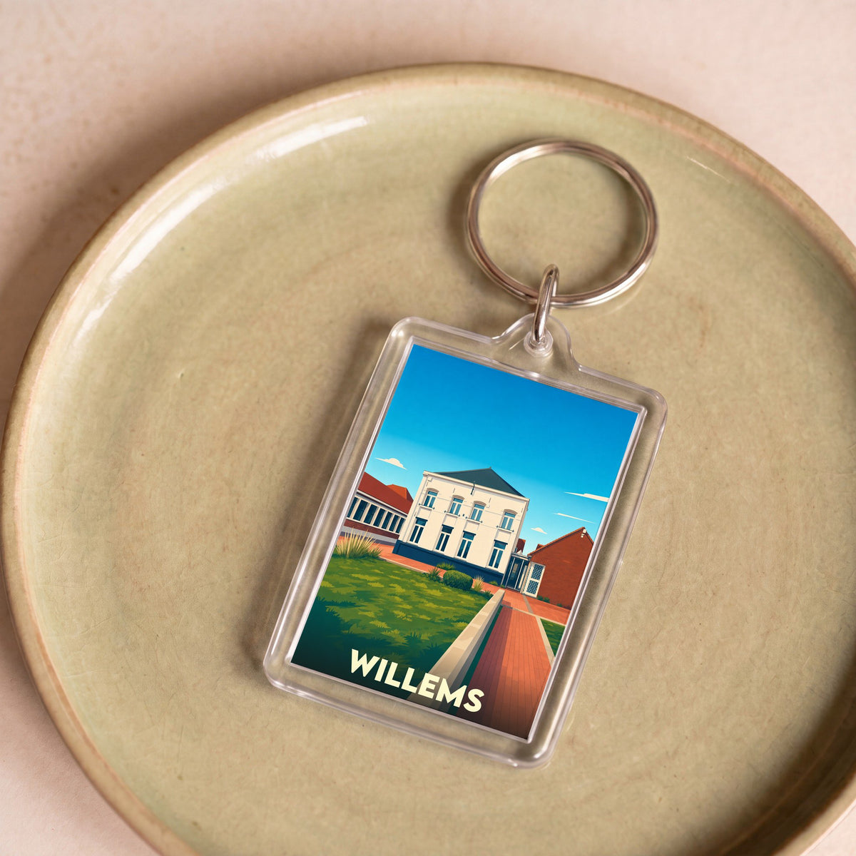 Porte-clés souvenir de la ville de Willems avec une illustration stylisée d'un bâtiment blanc.