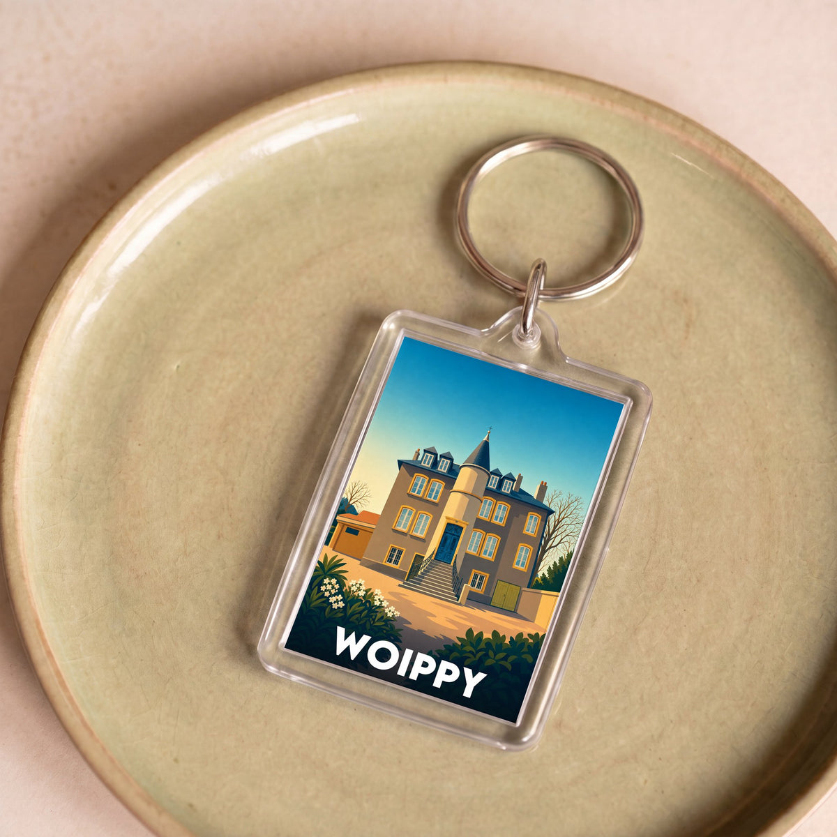 Porte-clés souvenir de la ville de Woippy avec une illustration stylisée.