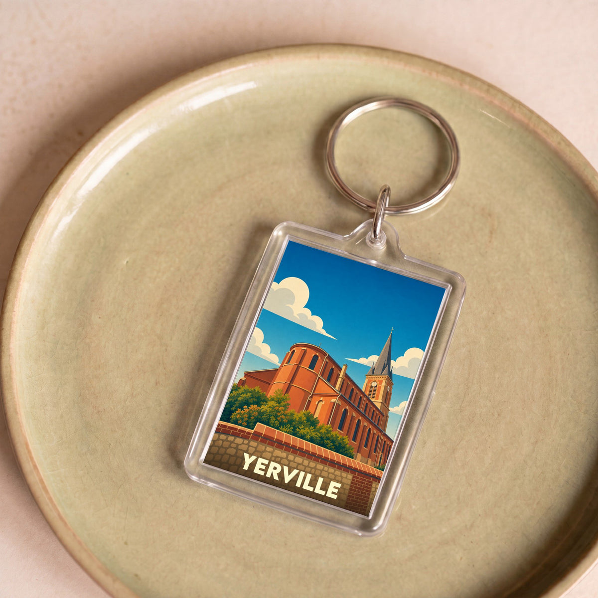 Porte-clés souvenir de la ville de Yerville avec une illustration stylisée de son église.