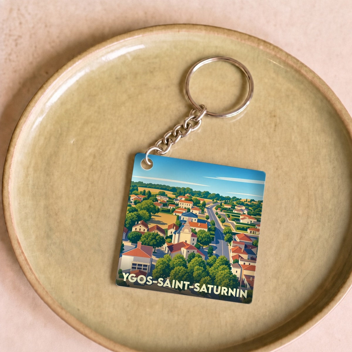 Porte-clés souvenir de la ville de Ygos-Saint-Saturnin avec une illustration stylisée.
