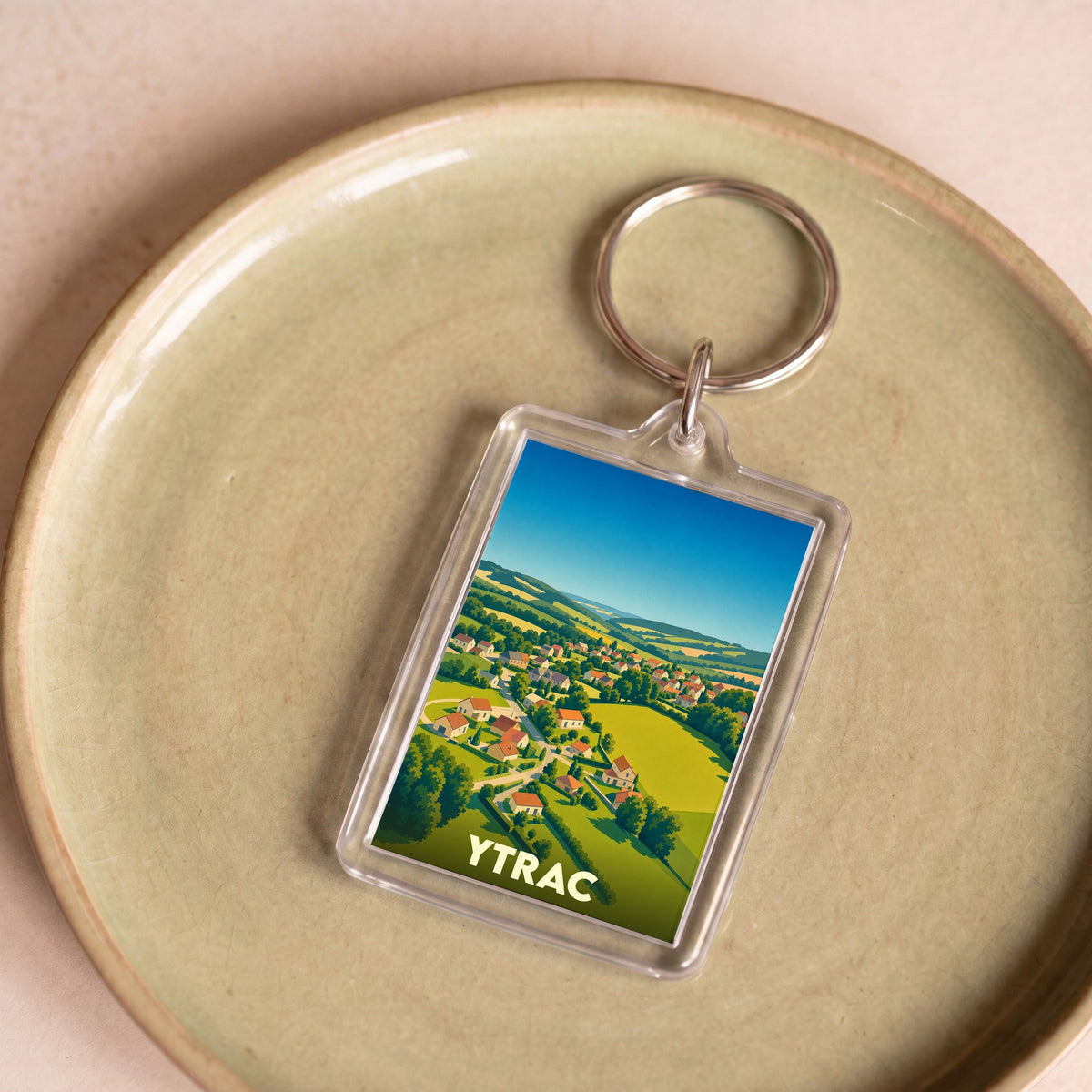 Porte-clés souvenir de la ville d'Ytrac avec une illustration stylisée.