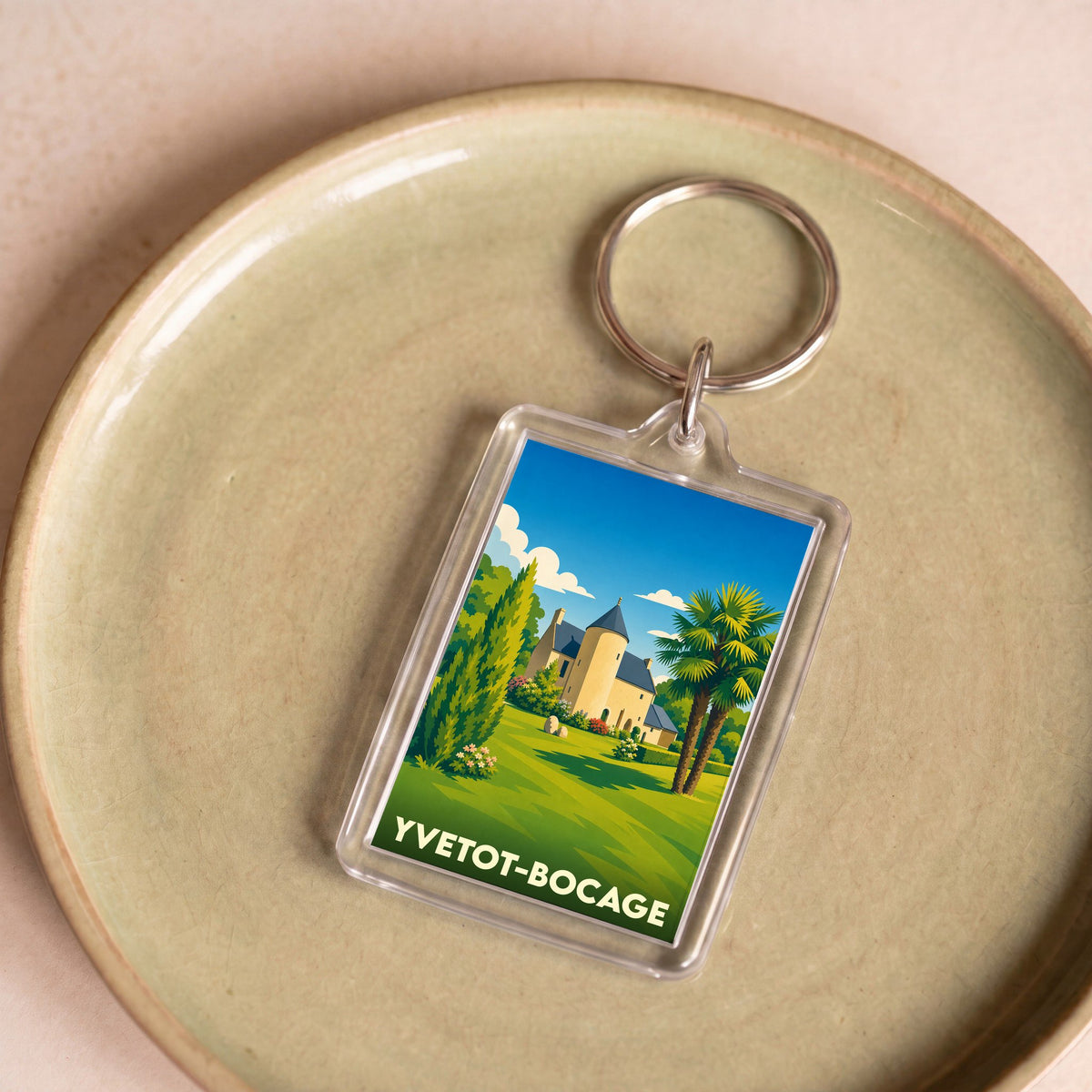 Porte-clés souvenir de la ville de Yvetot-Bocage avec une illustration stylisée d'un château.