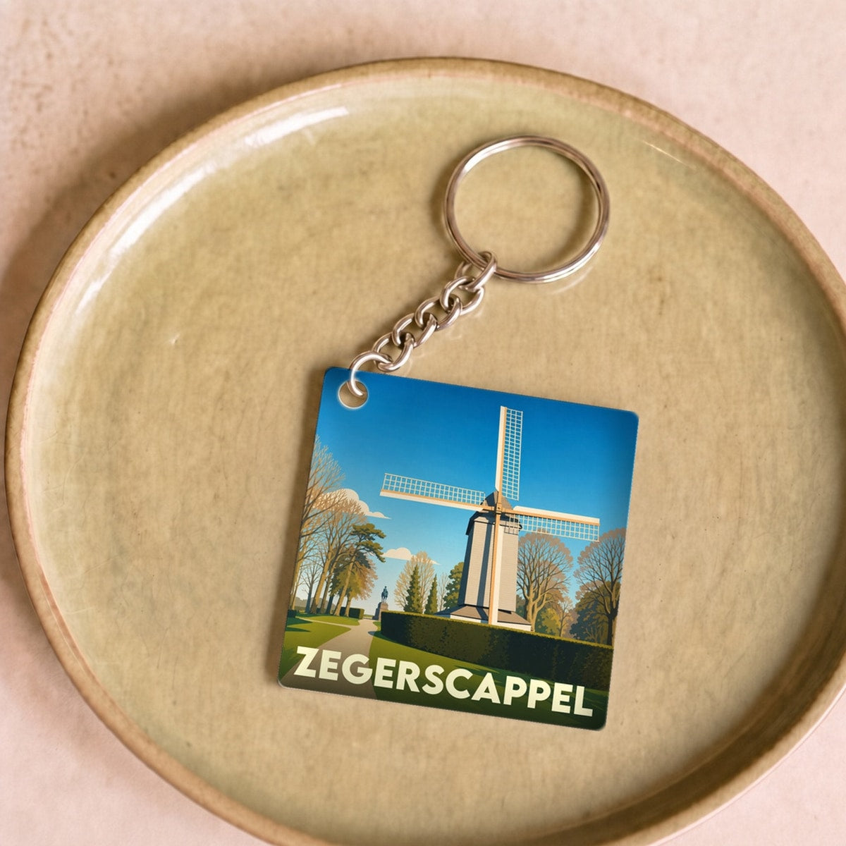 Porte-clés souvenir de la ville de Zegerscappel avec une illustration stylisée d'un moulin à vent.