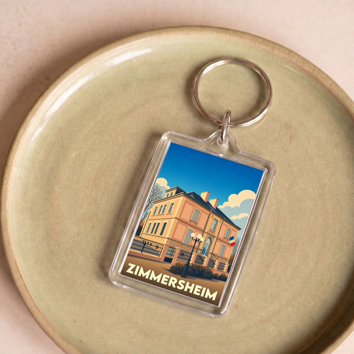 Porte-clés souvenir de la ville de Zimmersheim avec une illustration stylisée.