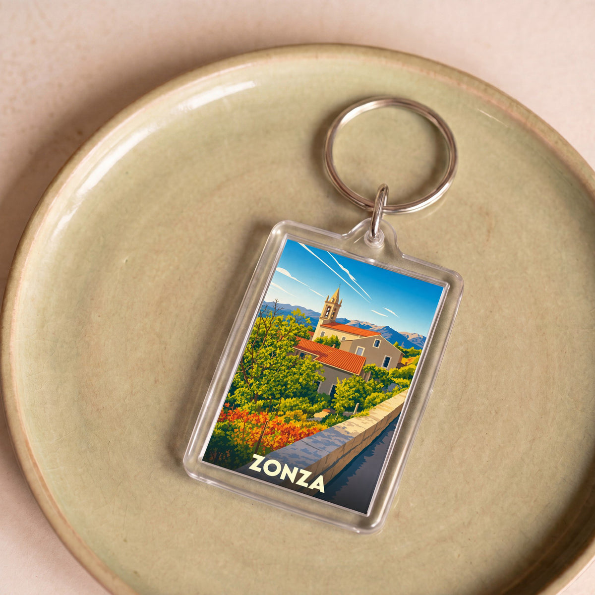 Porte-clés souvenir de la ville de Zonza avec une illustration stylisée.