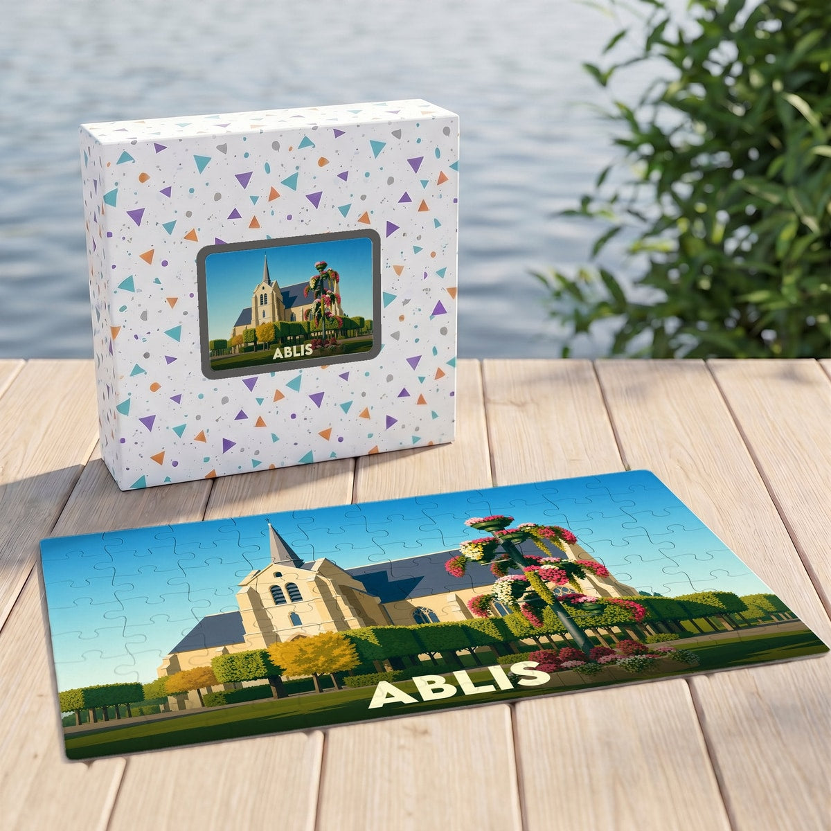 Puzzle souvenir de la ville d'Ablis avec une illustration stylisée de son église et de ses jardins fleuris.