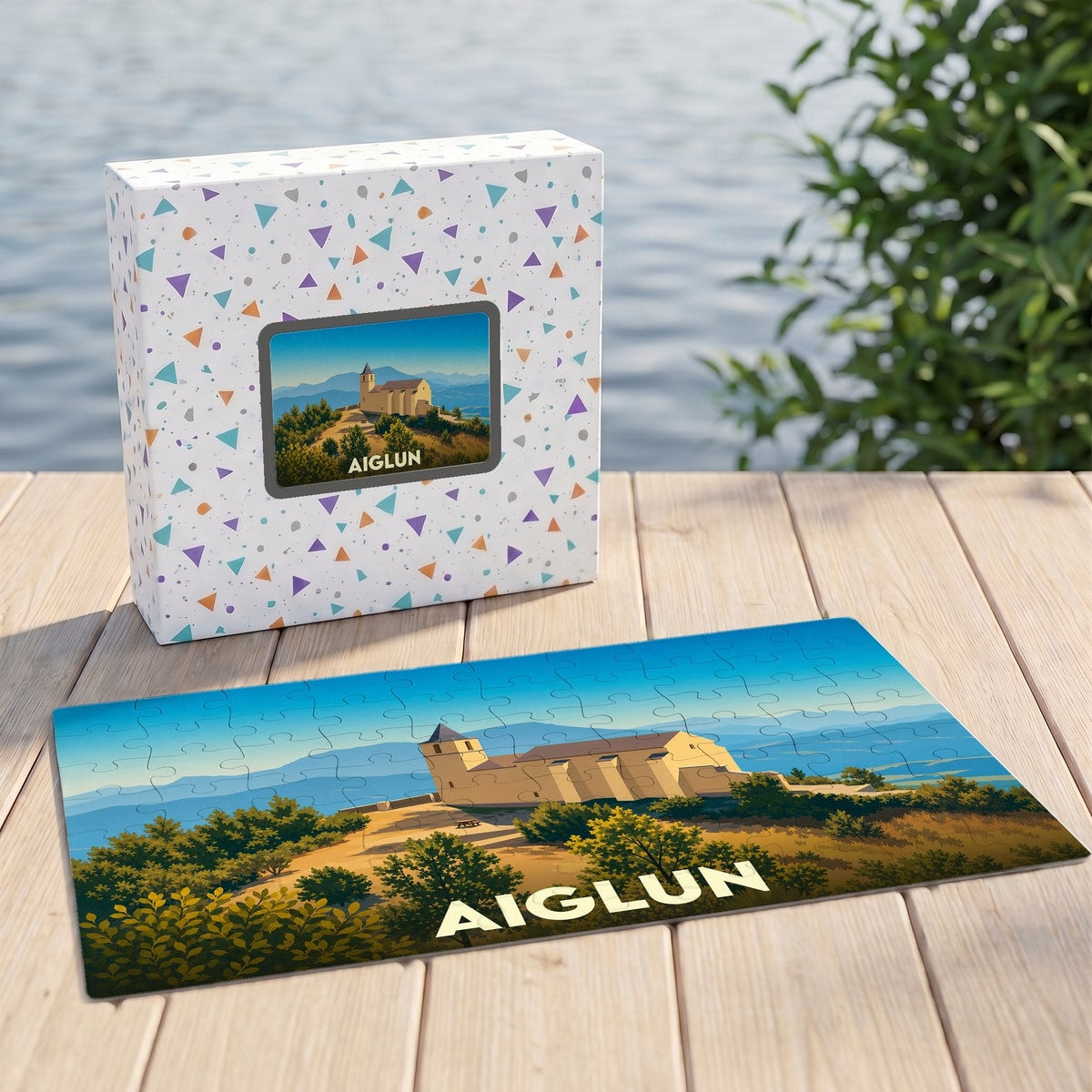 Puzzle souvenir de la ville d'Aiglun avec une illustration stylisée d'un bâtiment historique sur une colline.
