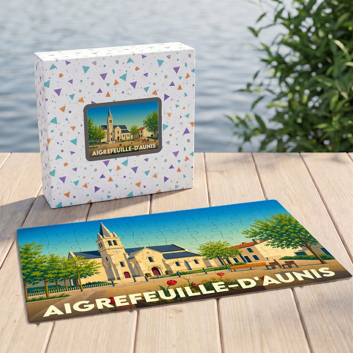 Puzzle souvenir de la ville d'Aigrefeuille-d'Aunis avec une illustration stylisée de son église et de sa place.