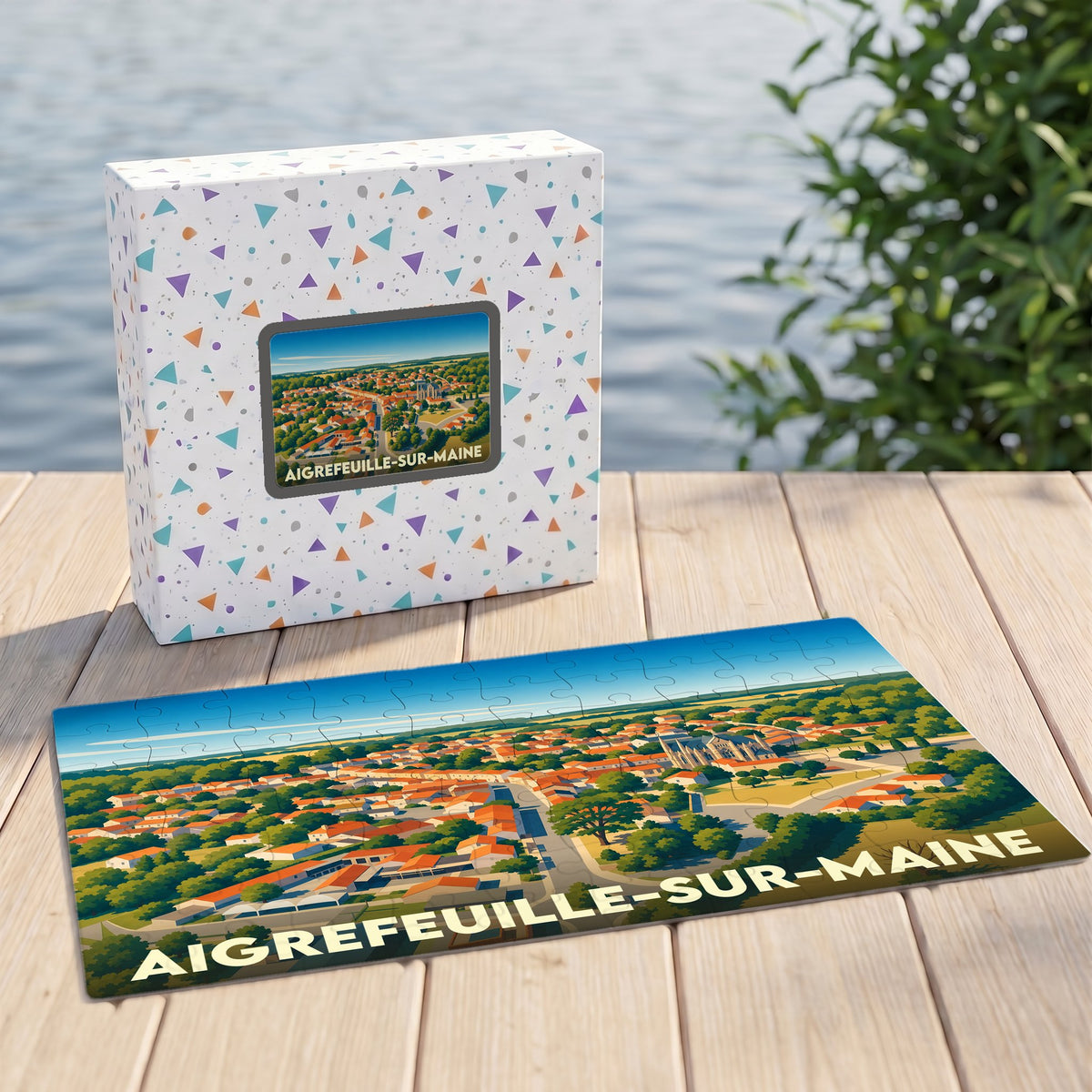 Puzzle souvenir de la ville d'Aigrefeuille-sur-Maine avec une illustration stylisée vue du ciel.