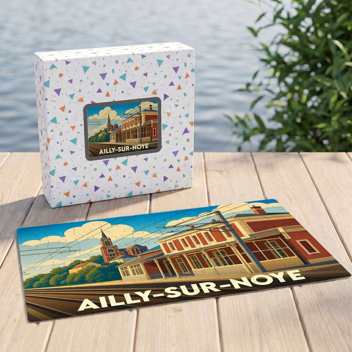 Puzzle souvenir de la ville d'Ailly-sur-Noye avec une illustration stylisée d'une gare et son église.