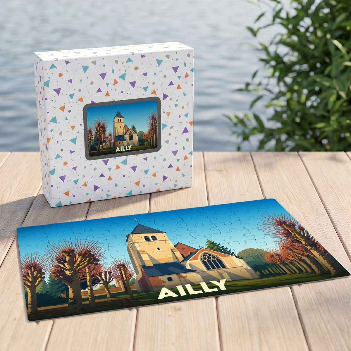 Puzzle souvenir de la ville d'Ailly avec une illustration stylisée d'une église et de son parc.